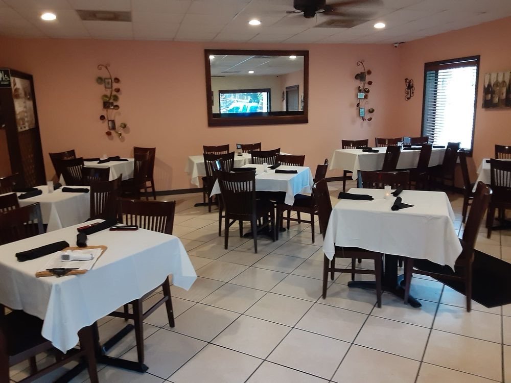 Indoor dining room with white tablecloths at New York Pasta Garden