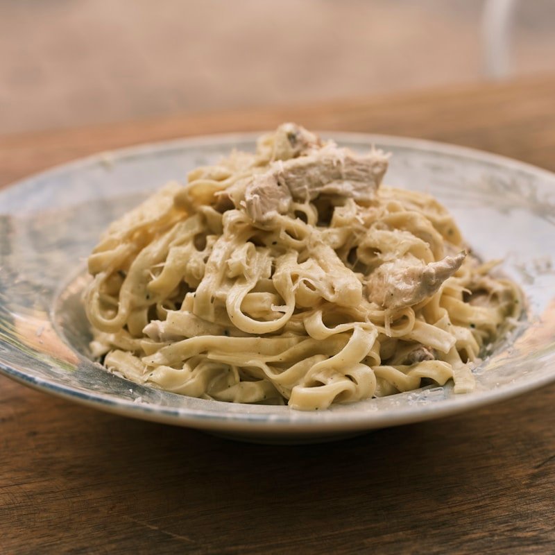 Fettuccine Alfredo topped with Parmesan cheese