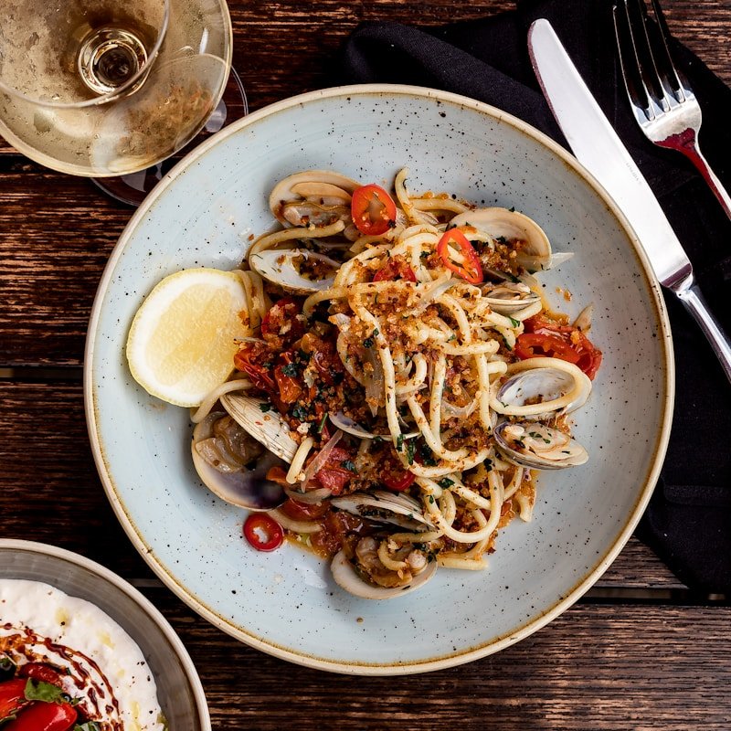 Pasta Puttanesca with olives, capers, and tomato sauce